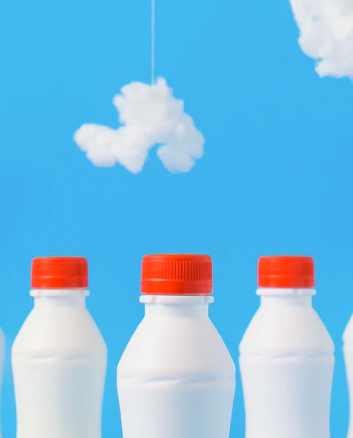 milk bottle with blue sky and white cloud background